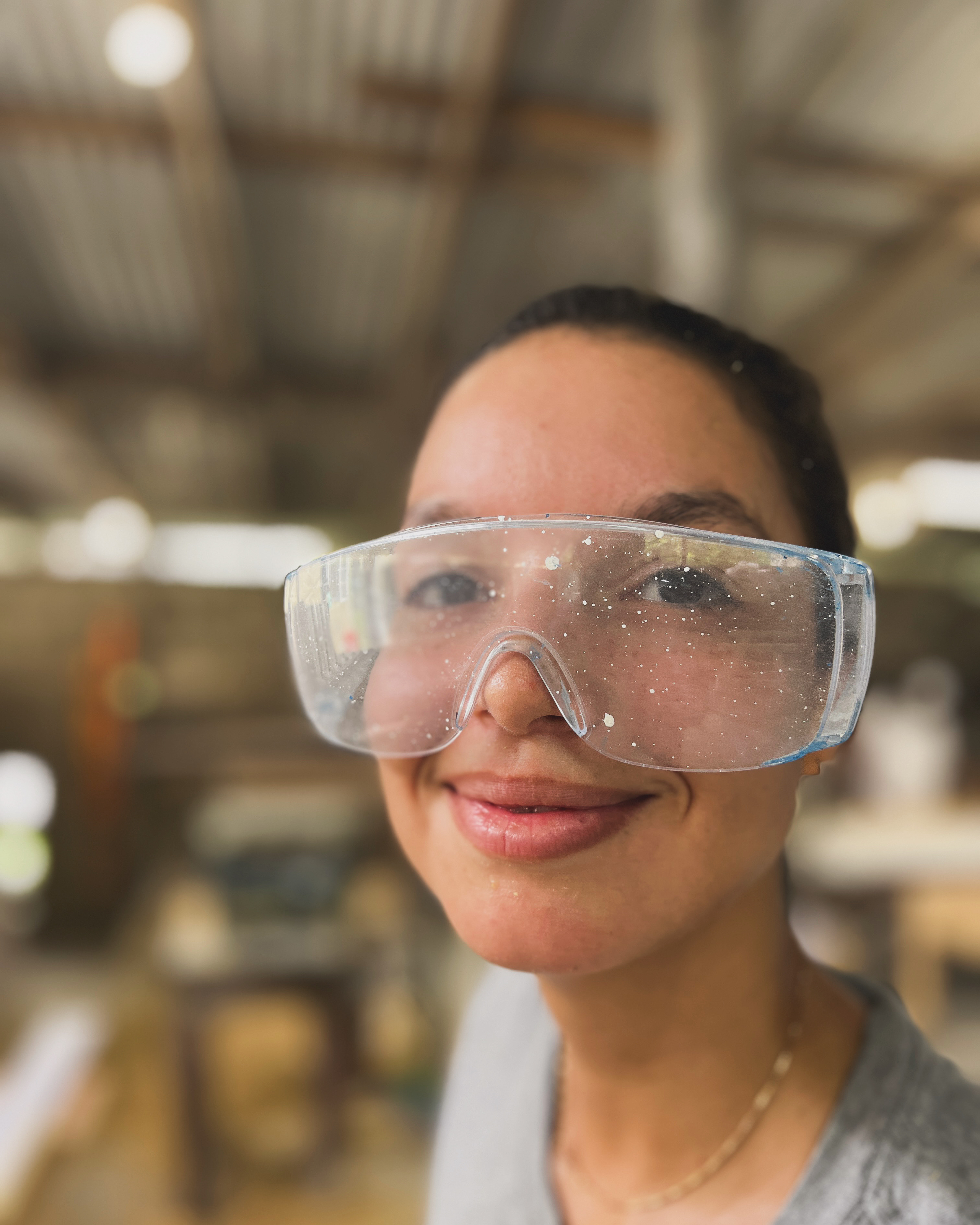 Akilah wearing safety glasses in the workshop